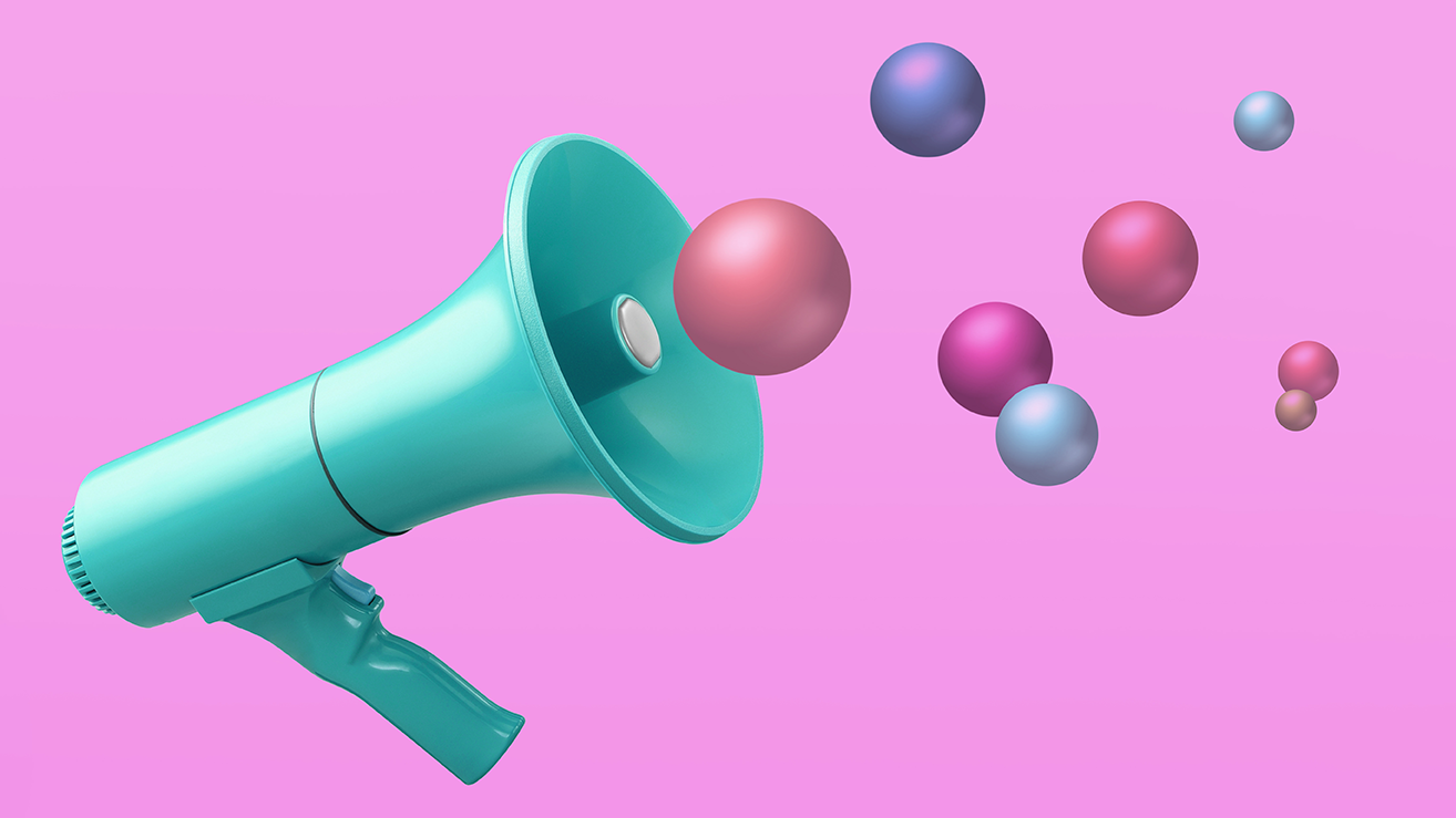 Megaphone on pink background with conceptual colourful balls spheres in air