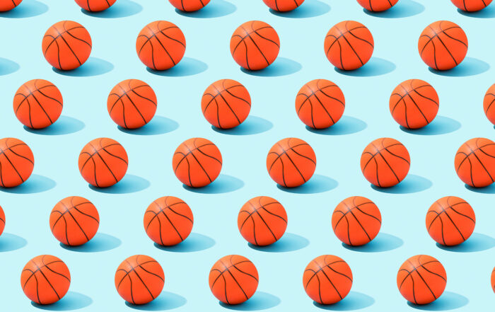Pattern of basketballs on blue background.