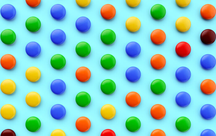 colorful candies in a pattern on a blue background