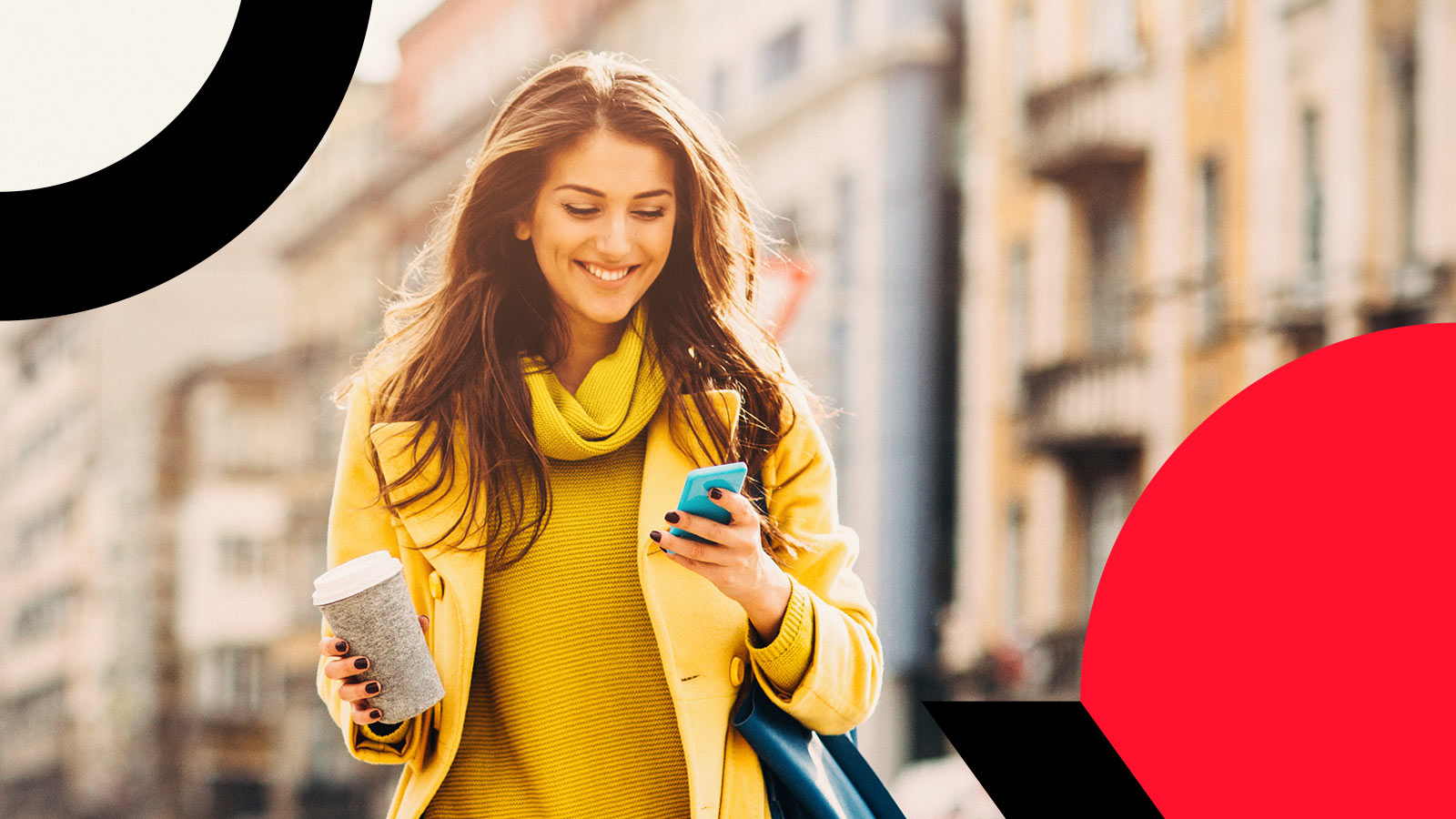 Person wearing yellow walking in the city while holding cellphone and coffee mug