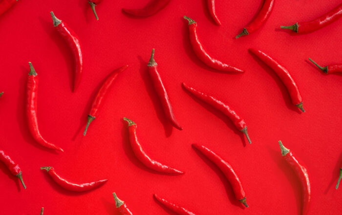 red chili peppers on red background