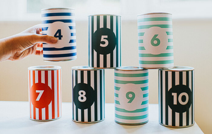 Multi-colored striped cans numbered and stacked