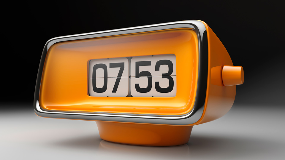 Bright orange alarm clock with flip numbers. Mid-century modern