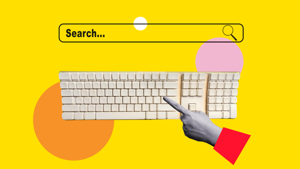 Hand typing on a keyboard into a search bar
